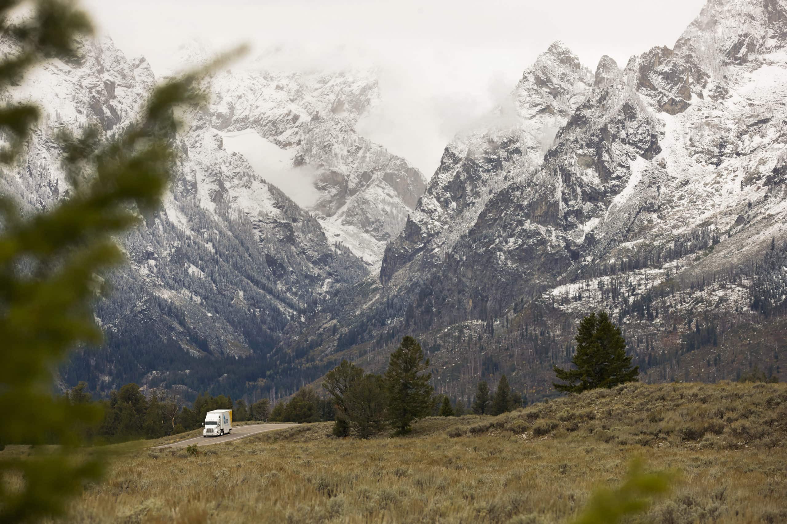United Van Lines moving truck driving in snowy winter mountains