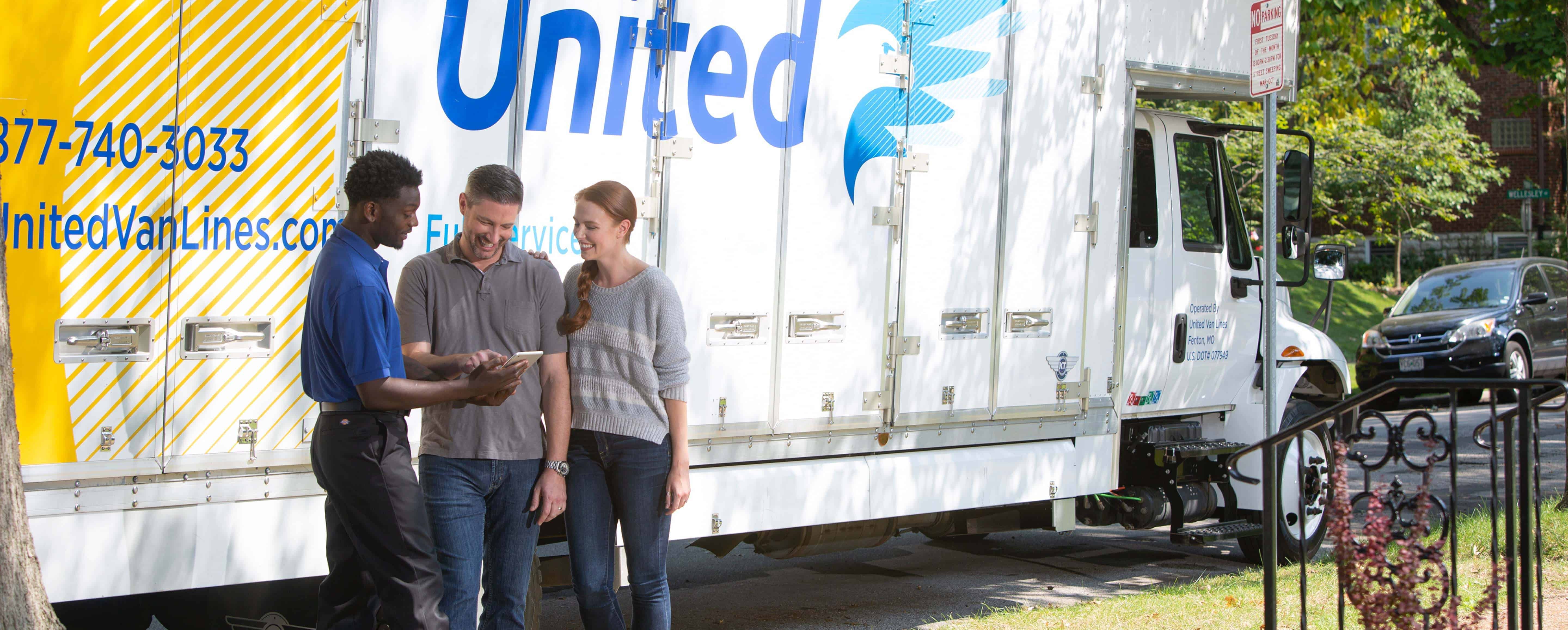 America's #1 Moving Company - photo of a couple and their moving agent next to a moving truck - United Van Lines